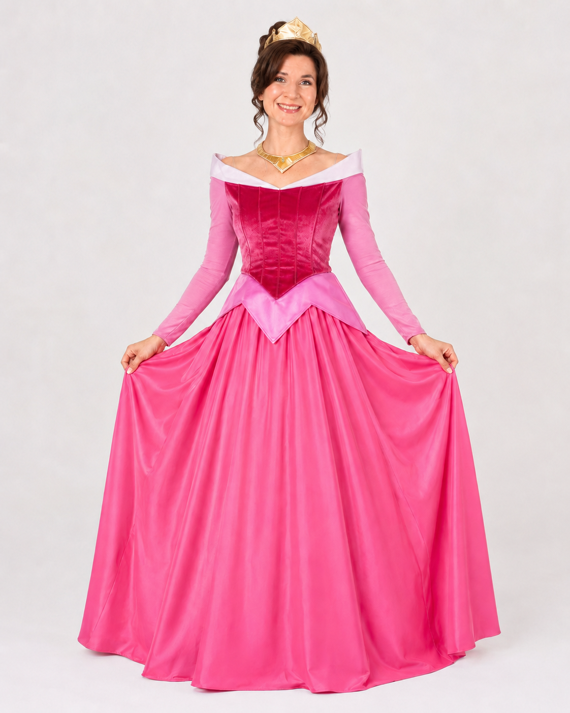 Performer smiling in a pink royal princess costume